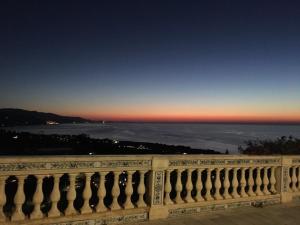 a view of the ocean from a balcony at sunset at I Tre Colori della Sicilia in Santo Stefano di Camastra