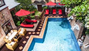 an overhead view of a swimming pool with chairs and umbrellas at Paradise Samui Villa (Villa 2) in Chaweng