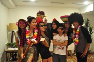 a group of people posing for a picture in a room at K2 Guesthouse Central in Singapore