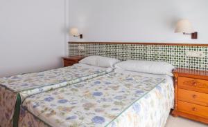 מיטה או מיטות בחדר ב-Apartamentos Mexico