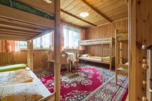 a room with two bunk beds and a table at Pokoje u Bobików in Ząb