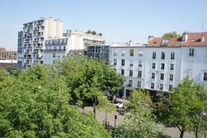 um grupo de edifícios numa cidade com árvores em Hôtel Edgar Quinet em Paris