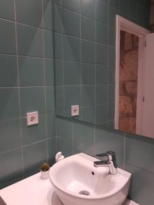 W łazience znajduje się umywalka i lustro. w obiekcie Oporto Foz House close to the beach w Porto