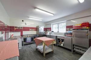 a large kitchen with a pink table in it at Pokoje u Bobików in Ząb