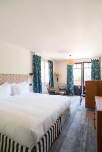 a bedroom with a large bed with blue curtains at La Guitoune in Pyla-sur-Mer