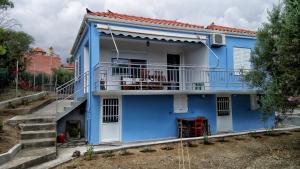a blue and white house with a balcony at Home by the sea in Monemvasia