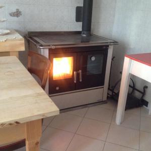 a kitchen with an oven with a fire in it at B&B Lattemiele in Fontanellato