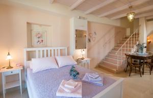 a bedroom with a bed with two towels on it at RETRO 51 in Rethymno Town