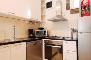 a small kitchen with a sink and a microwave at Apartment Brane in Solin