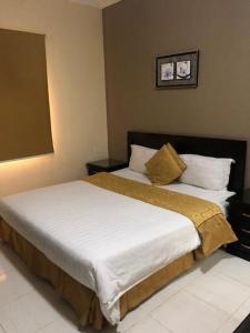 Postel nebo postele na pokoji v ubytování Safwt Aldyar Furnished Units