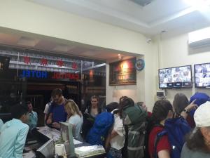 a group of people sitting in a restaurant at Capitol One in Phnom Penh