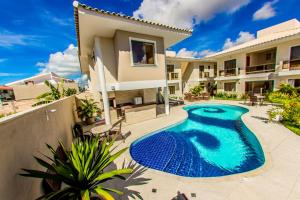 a swimming pool in the backyard of a house at Residencial Portinari LTDA in Porto Seguro