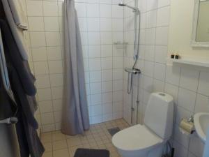 a bathroom with a shower with a toilet and a sink at Hotell Vita Hästen Hästveda in Hästveda