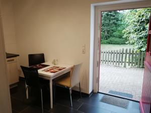 a dining room with a table and chairs and a window at Apartment am Park - Erica in Schneverdingen