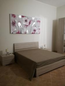 a bedroom with a bed and a painting on the wall at Residence Salento in Palmariggi +27 photos