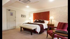 a hotel room with a bed and a chair at Honest Lawyer Hotel in Durham +27 photos