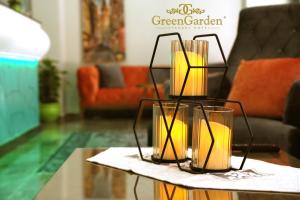 two candles on a table in a living room at Green Garden Hotel - Bahçelievler in Istanbul