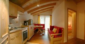 a kitchen and living room with a couch and a table at Ferienwohnung Steiner in Wald im Pinzgau