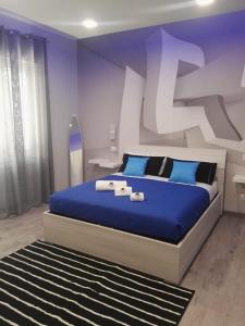 a bedroom with a king sized bed with blue sheets at B&B da Lillo in Frosinone