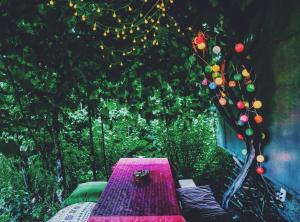 a picnic table in a garden with christmas lights at Aregak B&B and Tours in Goris