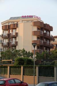 a building with a hotel sign on top of it at Coral Hotel in Pomorie
