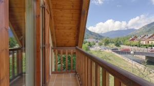 a balcony with a view of the mountains at Saplan Real Estate TERMAS in Les