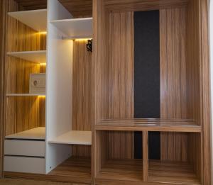 a walk in closet with wooden cabinets and a microwave at Kleopatra Celine Hotel in Alanya