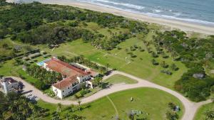 an aerial view of a house on the beach at Hotel Parque Oceánico in La Coronilla