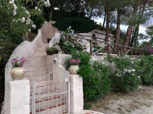 a staircase with a green umbrella and some flowers at Appartamenti Salato in Tropea