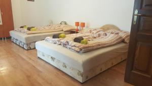 A bed or beds in a room at Bajusz Vendégház