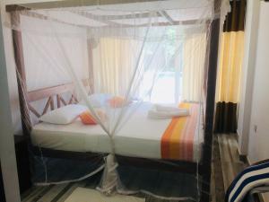 a bedroom with a bed with a canopy at Villa Kandy with Private Pool in Kandy