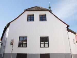 a white building with windows and a flag at Red Point in Tábor