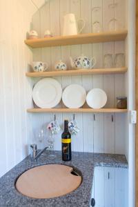 a kitchen counter with a sink and a bottle of wine at GoldenValley Shepherd's Hut in Dorstone