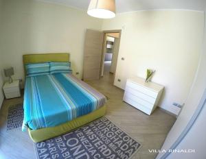 a bedroom with a bed and a dresser in a room at Villa RINALDI in Termoli