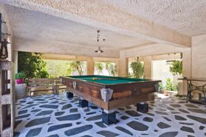 a pool table in the middle of a room at Philoxenia Studios 3 in Karpathos Town