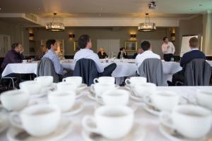 a group of people sitting at tables with cups at The Marine in Whitstable