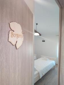 a bedroom with a butterfly sign on the wall at Casa Rossa Motovun in Motovun