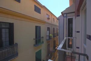 a view of an alley from a balcony of a building at Apartamentos Romero Luna in Málaga