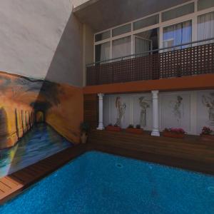 a swimming pool in a building with a painting on the wall at B&B "Domus Atilia" in Sagunto