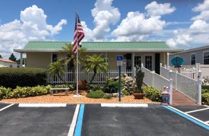 a building with an american flag in a parking lot at Woody's RV Resort LLC in Sebring