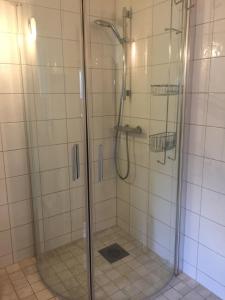 a shower with a glass door in a bathroom at Solhaga Kullahalvön in Jonstorp +36 photos