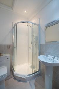 a bathroom with a glass shower and a sink at The Swan Hotel in Clitheroe