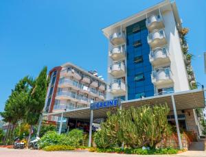 a building with a blue sign in front of it at Kleopatra Celine Hotel in Alanya
