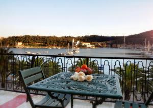 a table with a bowl of fruit on a balcony at Hotel Della Baia in Portovenere