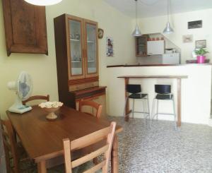 a kitchen and dining room with a wooden table at la fontanella in Militello in Val di Catania