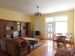 a living room with a couch and a table at Bodzavirág Vendégház in Hegykő