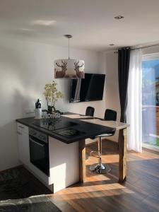 a kitchen with a black counter top and a desk at Haus Isabel in Rauris