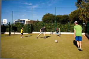 a group of people playing soccer on a field at Résidence les Tourelles in Sainte-Maxime +37 photos