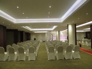 an empty room with white chairs and a stage at Executives Hotel - Azizia in Riyadh