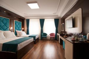 a hotel room with a bed and two chairs at Akbiyik Suite Boutique Hotel in Istanbul